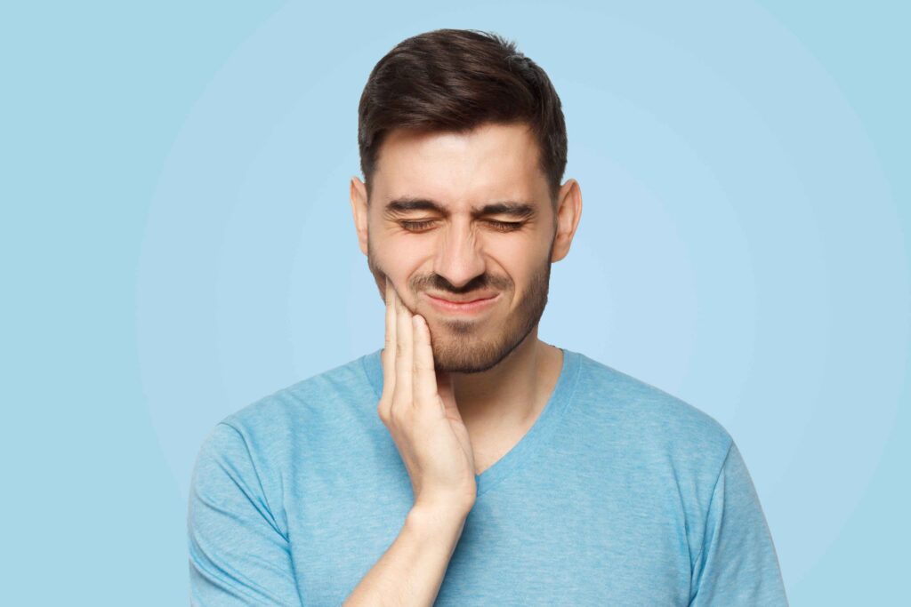 Man showing discomfort from a toothache.