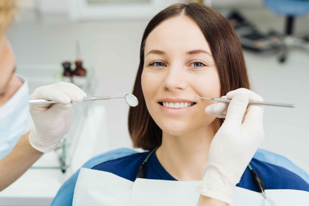 Dentist examining a patient's teeth during a dental checkup.
