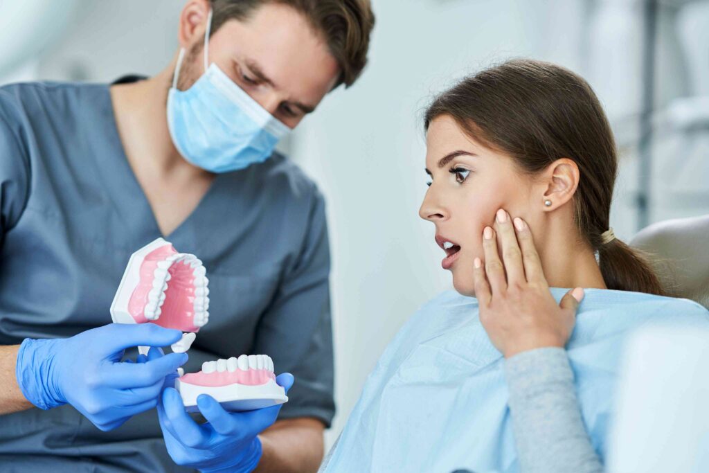 Dentist explaining a denture treatment option to a patient.